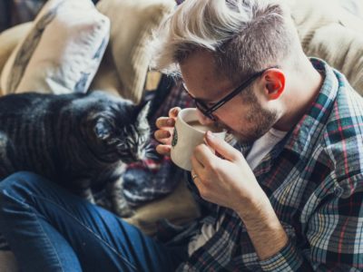 adult-male-on-couch-with-cat